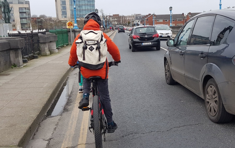 Boy cycling across Sarsfield Bridge Limerick