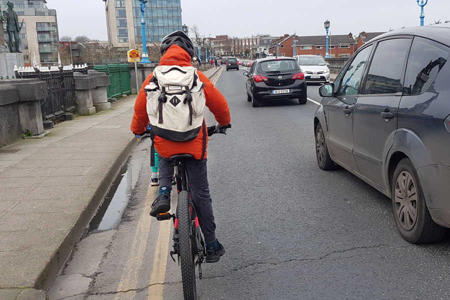 Boy cycling across Sarsfield Bridge Limerick