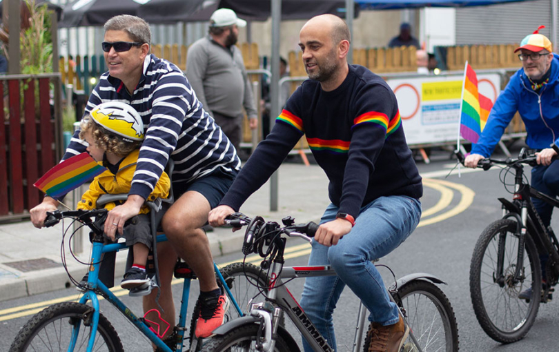 men cycling bikes in a bike parade