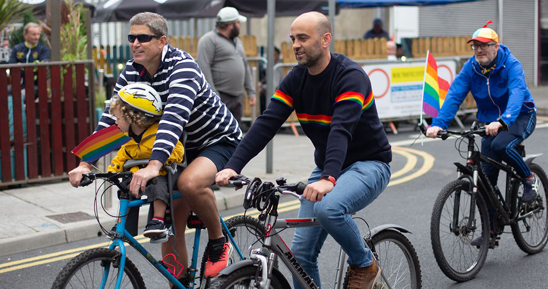 men cycling bikes in a bike parade