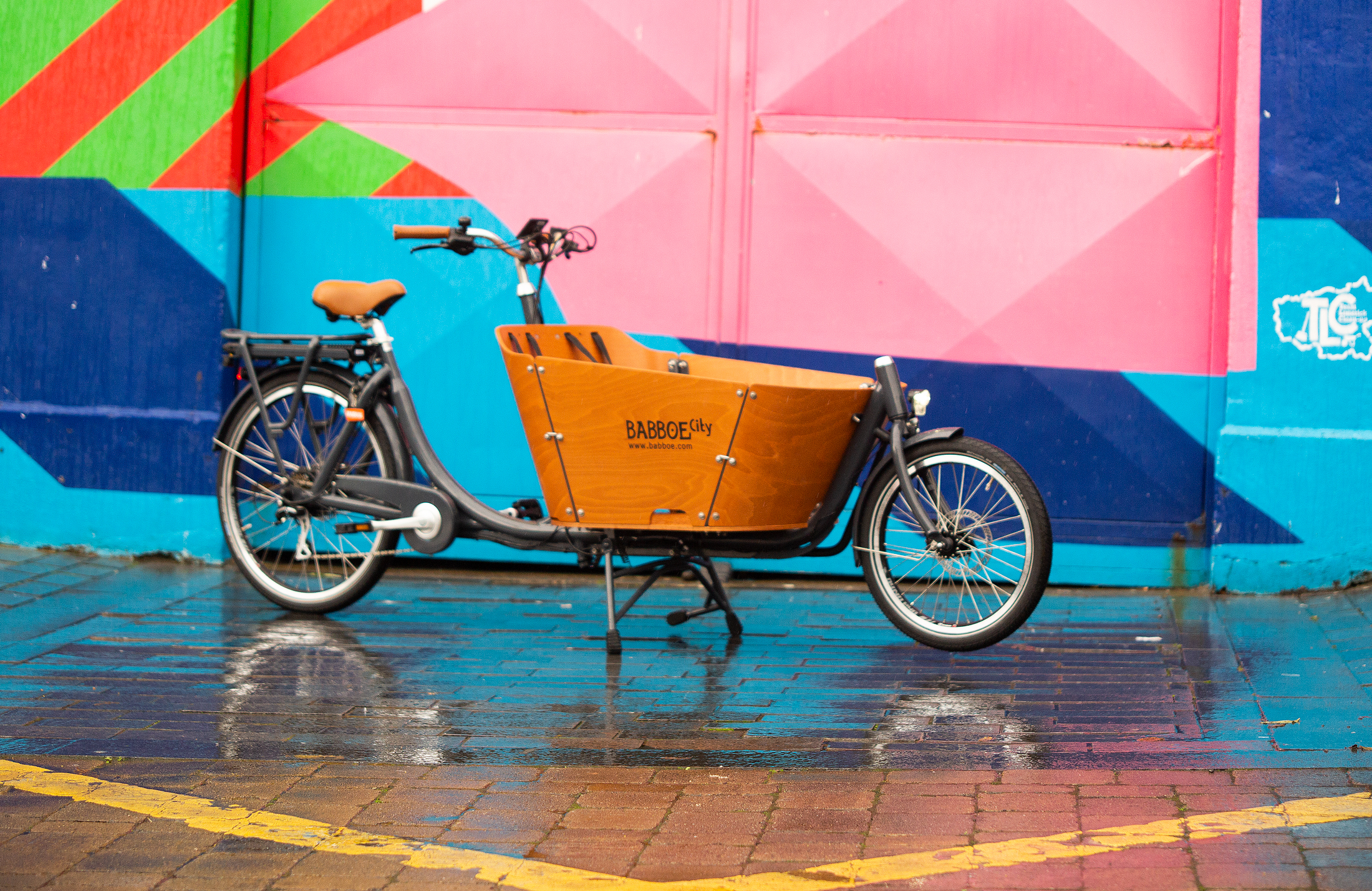 A Cargo Bike against a coloured on Thomas Street in Limerick